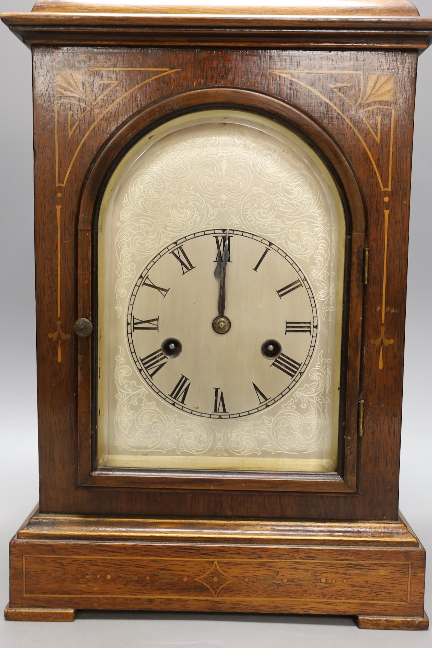 A late 19th century rosewood and marquetry mantel clock, 36 cms high.